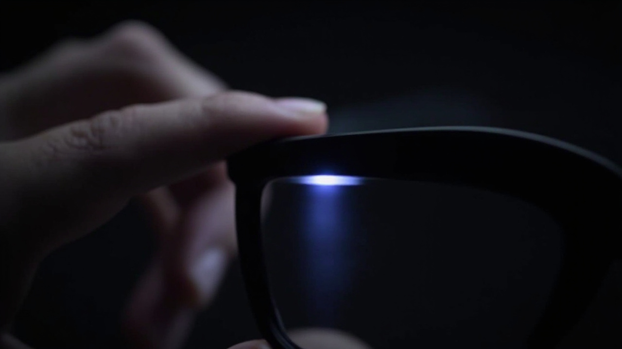 Fingertip tapping the capacitive touch strip on a matte-black glasses temple